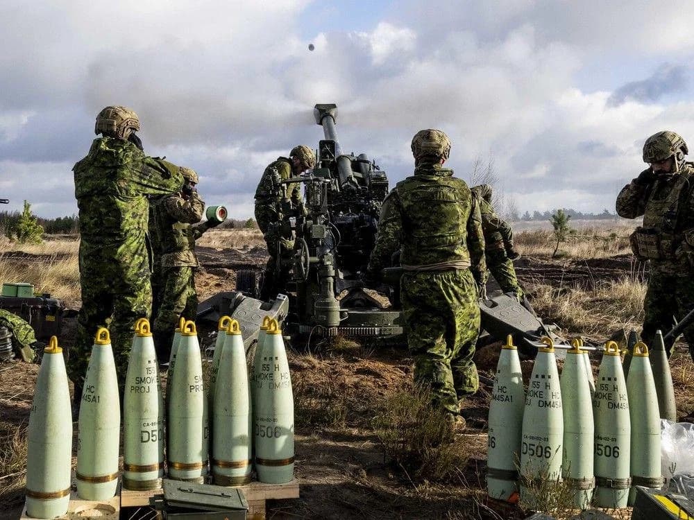 Canadian gunners on an M777 howitzer with 155mm rounds staged